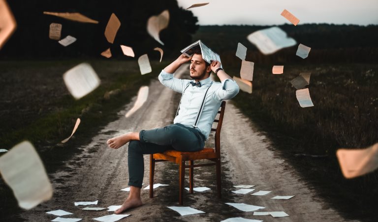 Article header image, man sitting on chair with book photo